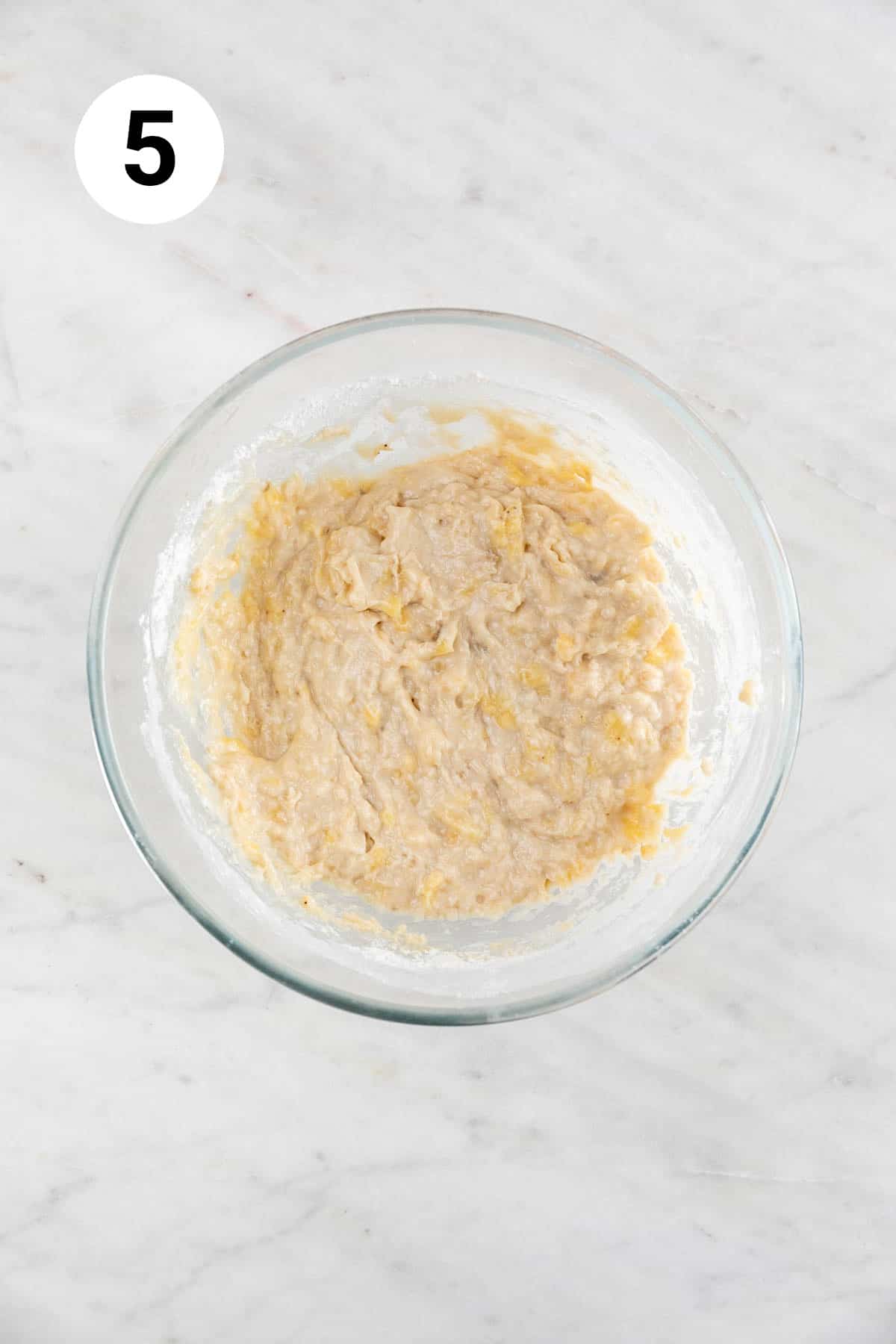 Vegan banana bread batter in a large mixing bowl before adding the chocolate chips.