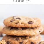 Lots of vegan chocolate chip cookies on a marble slab.