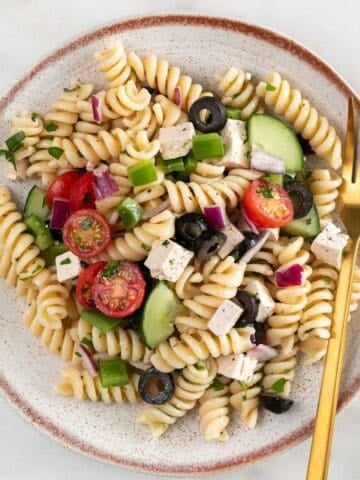 Vegan pasta salad on a plate with a fork.