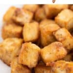 A photo of a dish with crispy pan-fried tofu cubes and the text crispy pan-fried tofu.