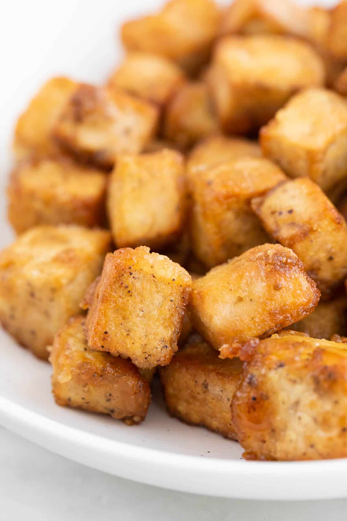 A dish with crispy pan-fried tofu cubes.