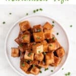 Overview of a dish with marinated tofu garnished with chopped chives and the text easy marinated tofu.