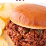 Vegan sloppy joes on white dish, accompanied by crispy potato chips.