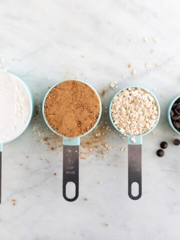4 measuring cups with food.