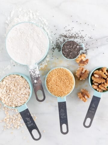 4 measuring cups and a tablespoon with food.