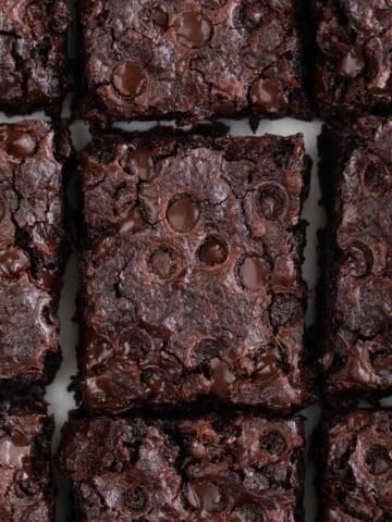 Overview of a vegan brownie cut into pieces.