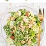 Vegan Caesar Salad arranged on a plate, accompanied by a fork.