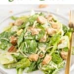 Plate of Vegan Caesar salad with fork and croutons in the background.