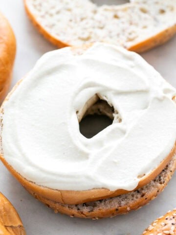 Vegan cream cheese spread on a bagel.