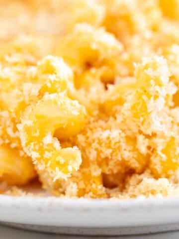 Vegan mac and cheese, baked in a white dish.
