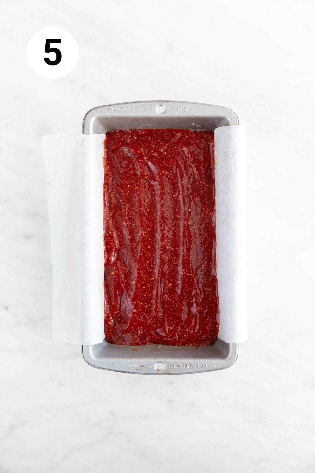 Loaf pan with vegan meatloaf before baking.