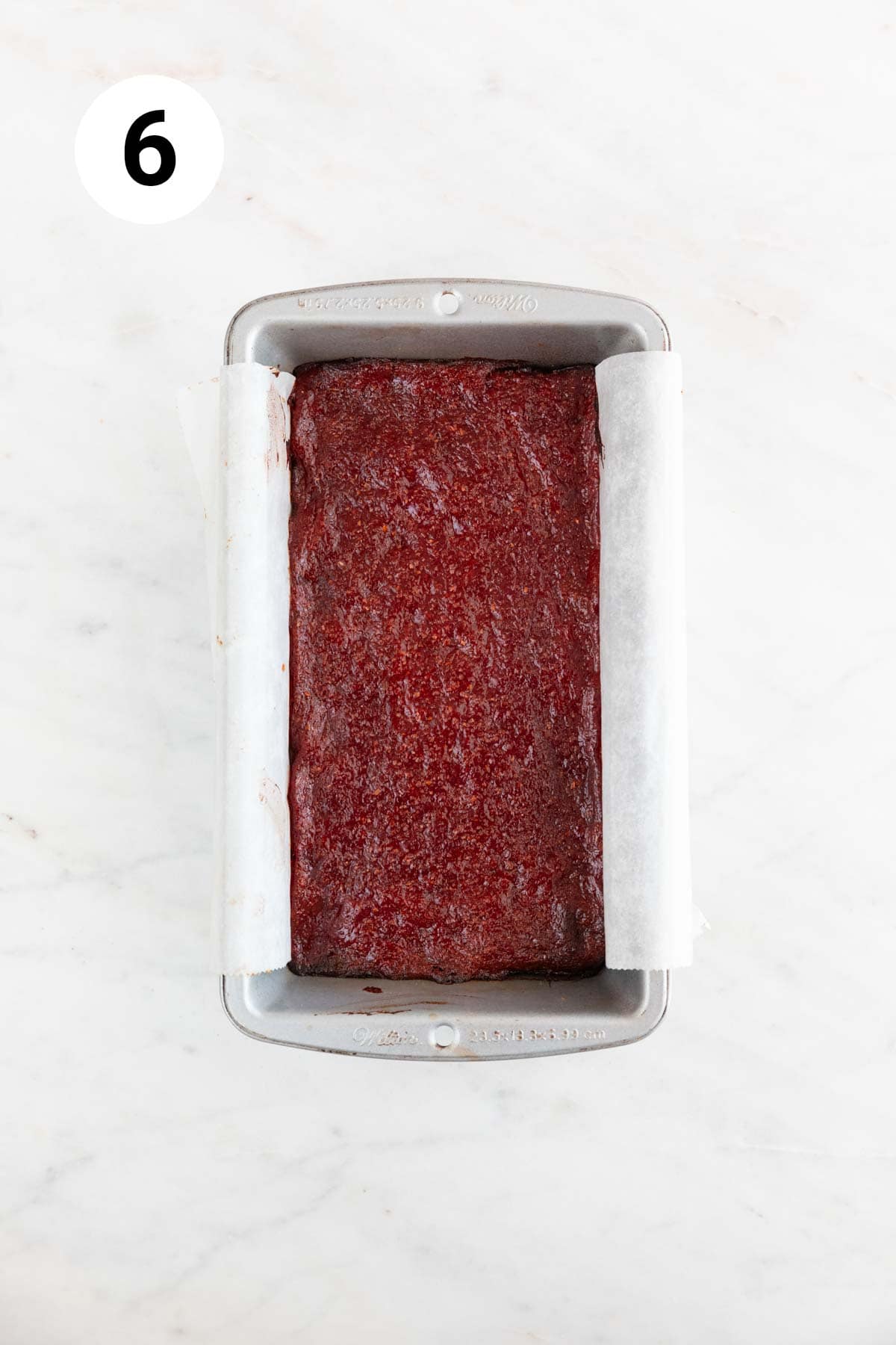 Loaf pan with baked vegan meatloaf.