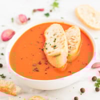 Square photo of a bowl of vegan tomato soup