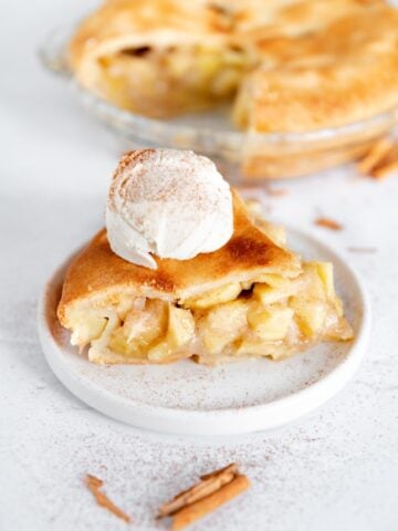 Photo of a slice of vegan apple pie with some ice cream