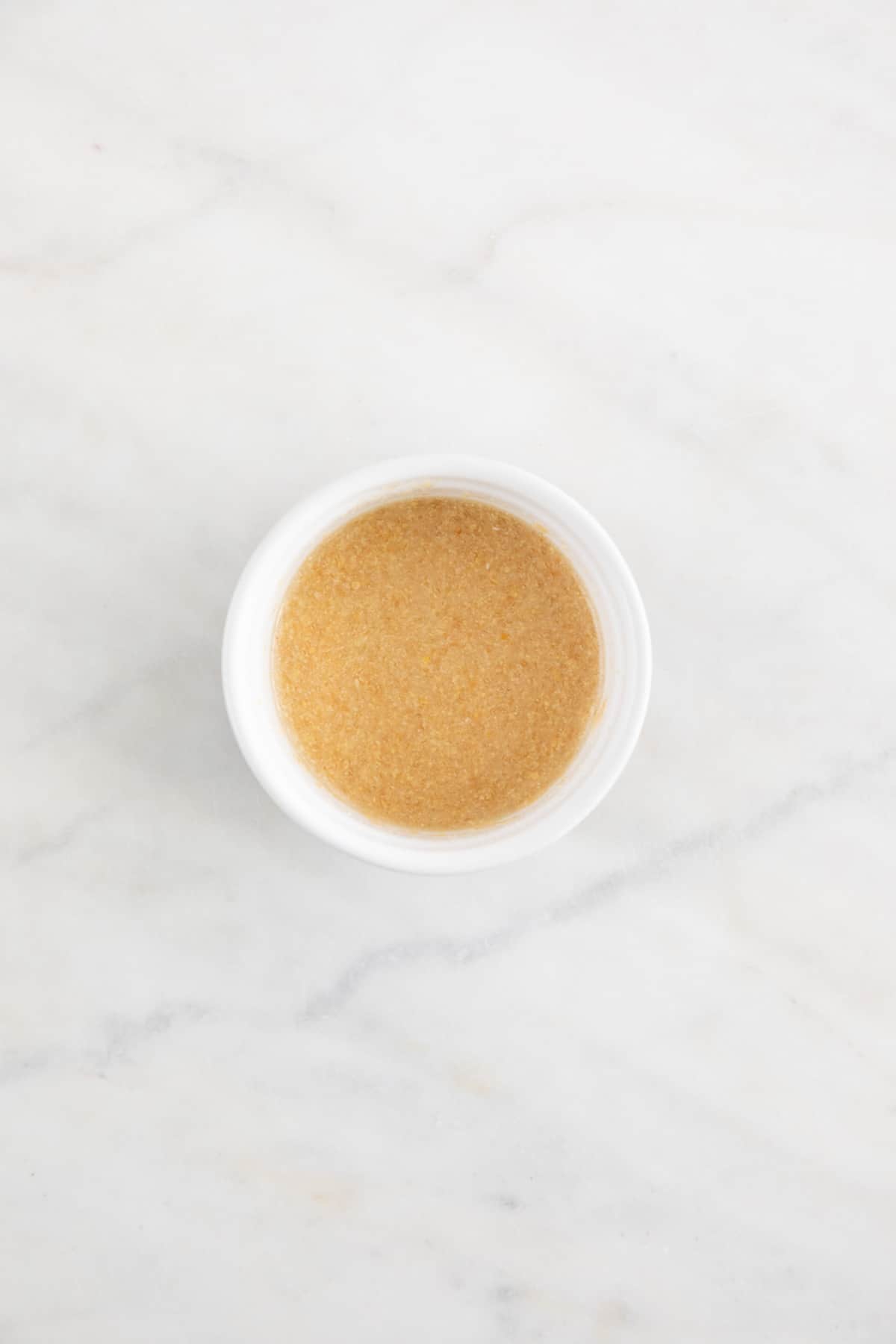 A homemade flax egg in a small bowl.