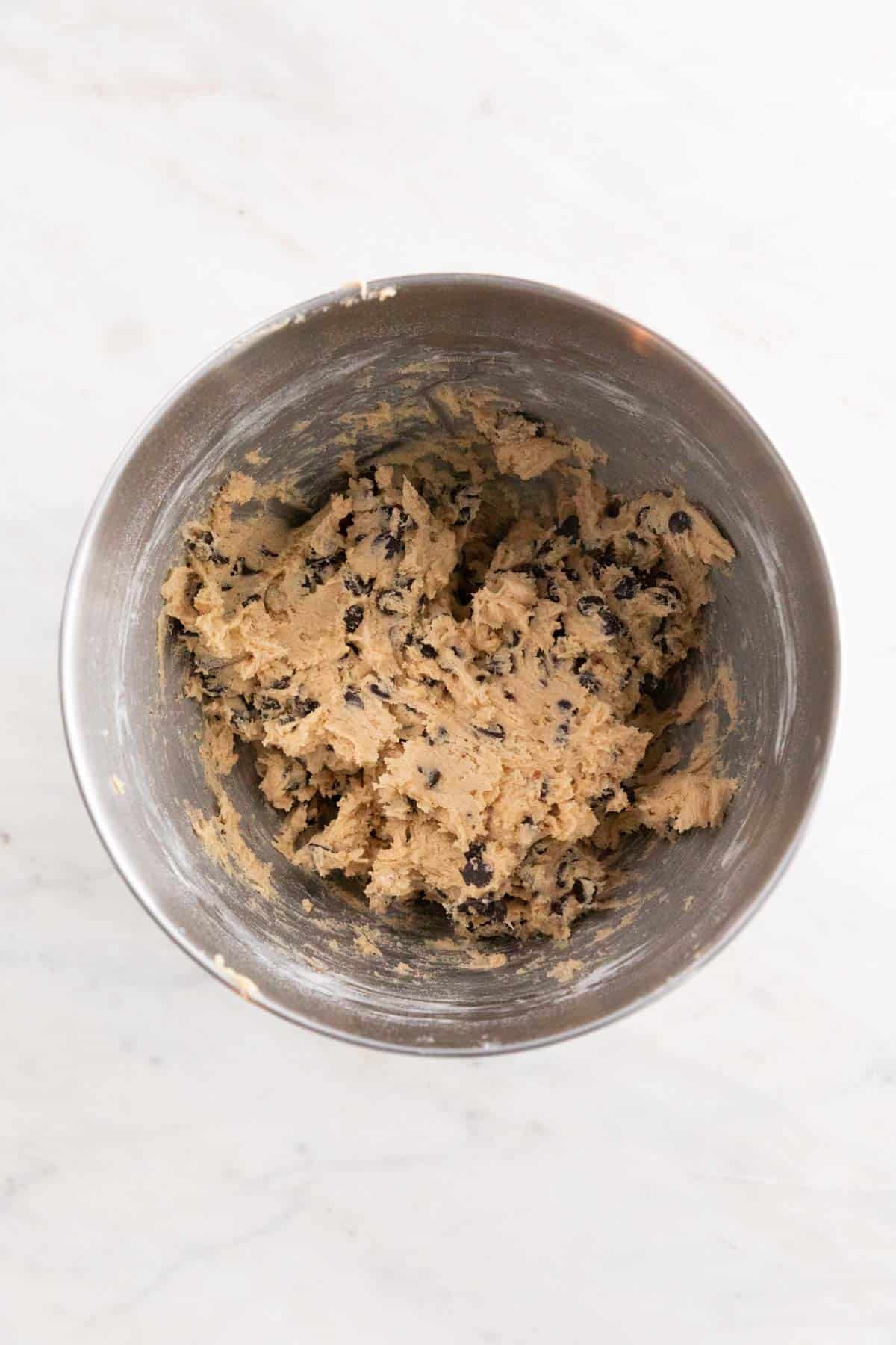 The dough after adding the vegan chocolate chips in a large bowl.