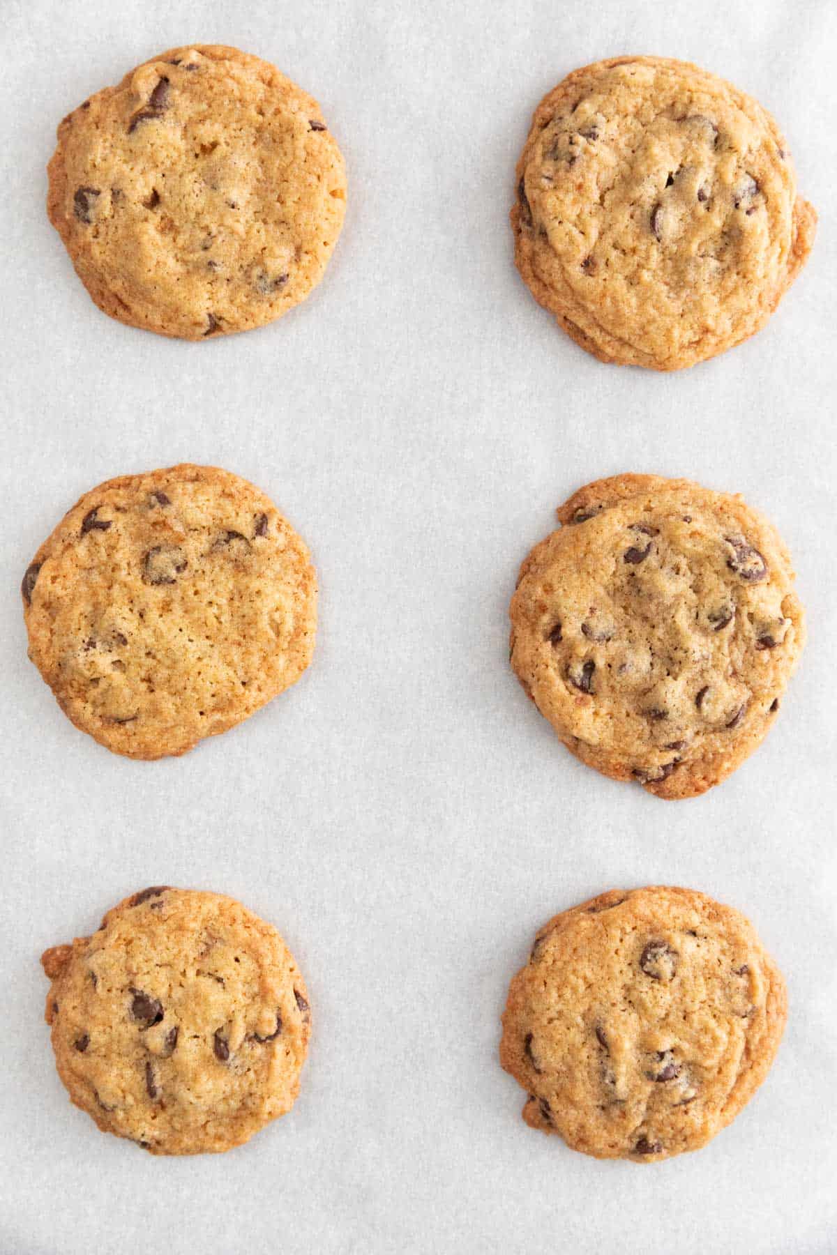 Baked vegan chocolate chip cookies onto a lined baking sheet.