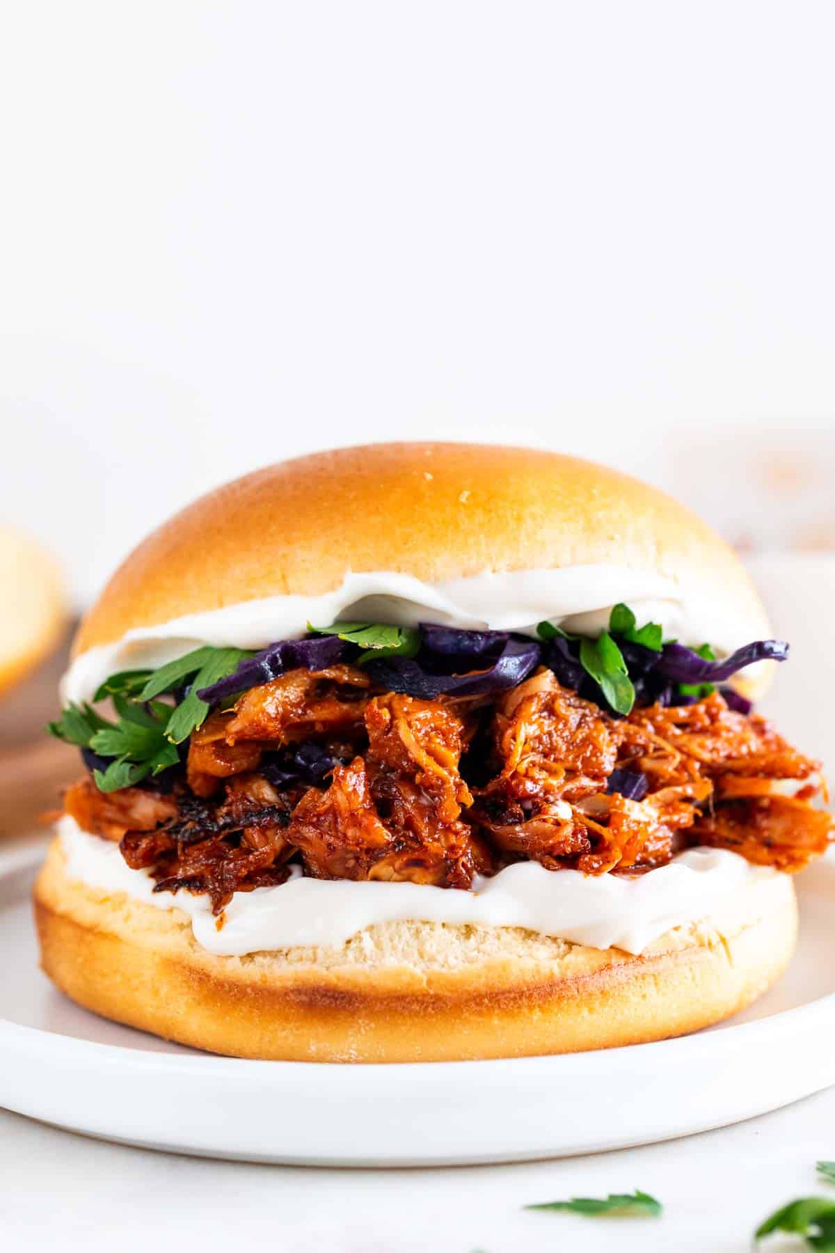 Vegan BBQ jackfruit pulled pork sandwich with vegan mayo and veggies.