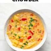 Vegan potato and corn chowder in a bowl garnished with parsley.