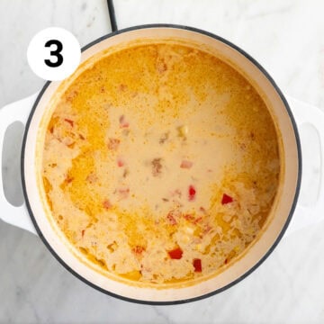 Cooked vegan potato and corn chowder in a large pot, ready for blending.